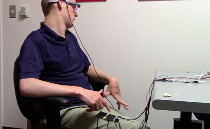 Participant using Google Glass with wearable touchpads that were placed on his thigh