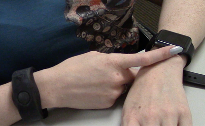 Participant pressing the right bezel of the smartwatch