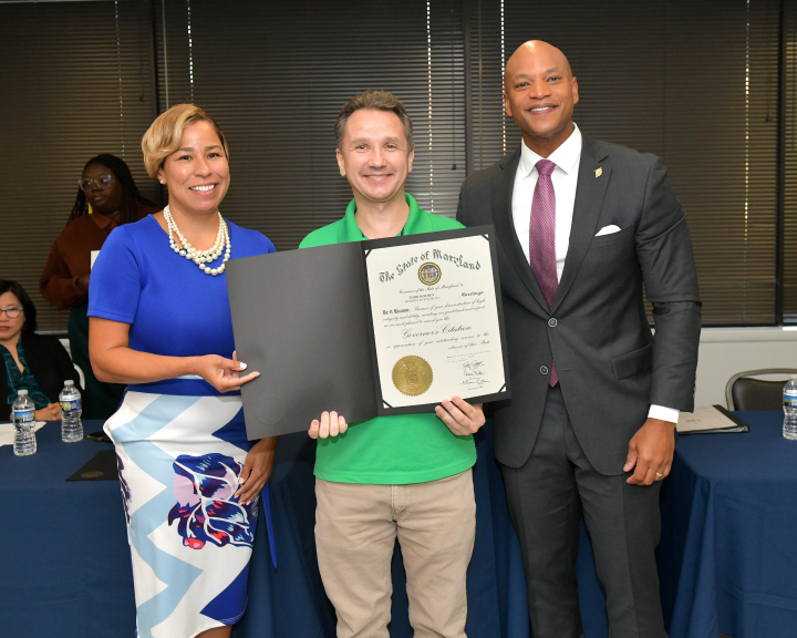 photo of Todd Holden (center) receives a Governor’s Citation from Governor Wes Moore (right) at the labor relations roundtable. Photo credit: Executive Office of the Governor